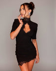 Black fitted dress with high collar and lace cutout detail; half sleeves and lace hem.