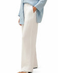 White wide-leg linen pants with elastic waist and long relaxed legs, ankle length.
