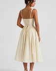 Back view of yellow gingham midi dress with corset-laced bodice and open low back