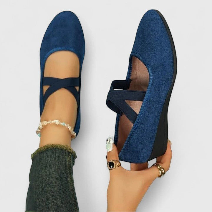 Blue wedge ballet flats with ankle strap and cross straps, open arch design.
