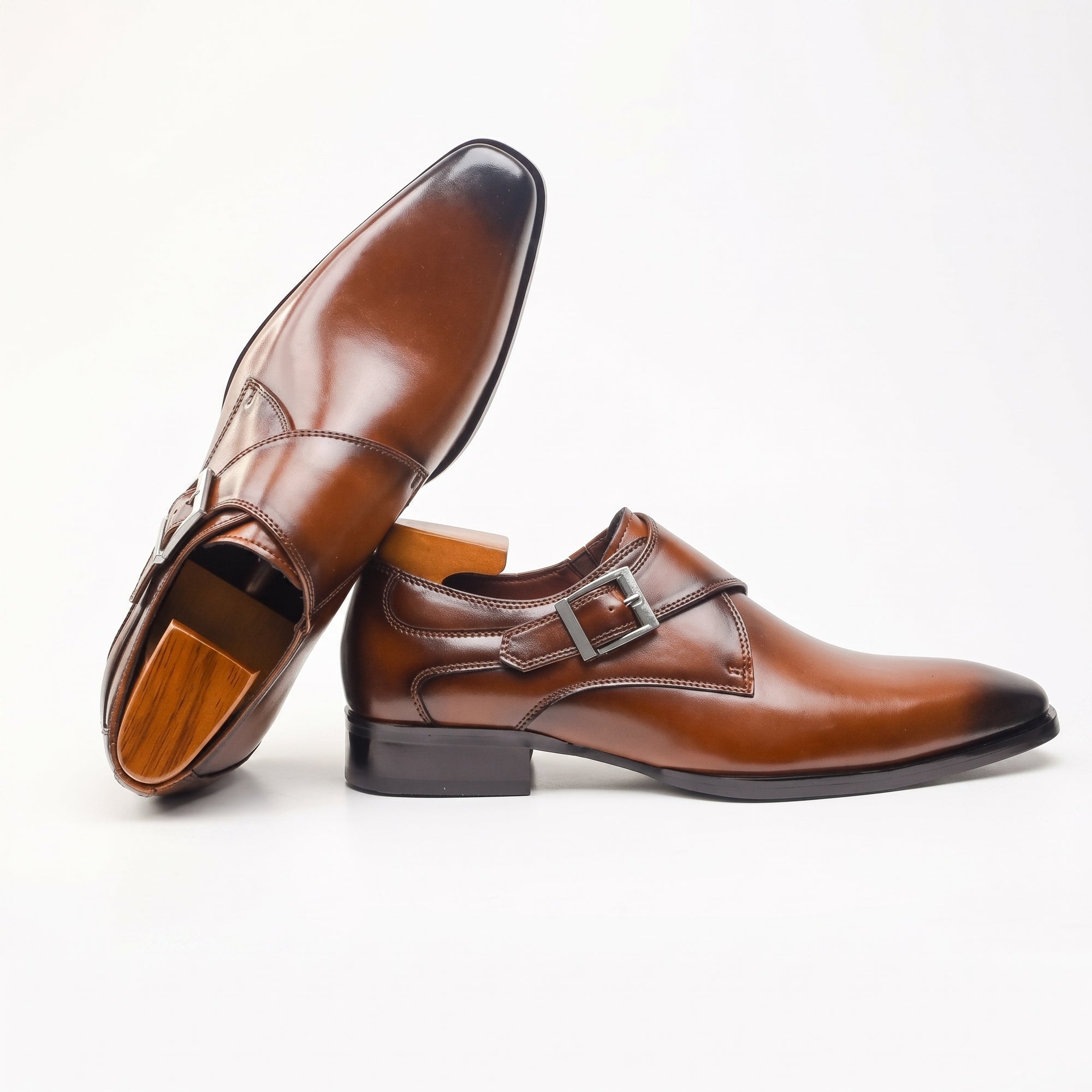 Brown leather buckle dress shoe, side view with visible sole and heel