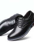 Black leather derby dress shoes, round toe lace-up with stitched seams and cushioned collar