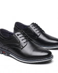 Black leather derby dress shoes with round toe, lace-up design and textured side panels