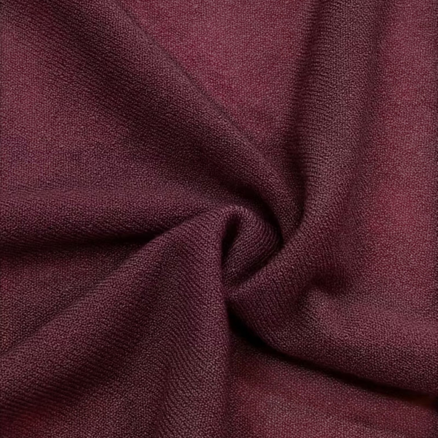 Dark red knit fabric close-up with soft textured weave