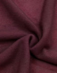 Dark red knit fabric close-up with soft textured weave