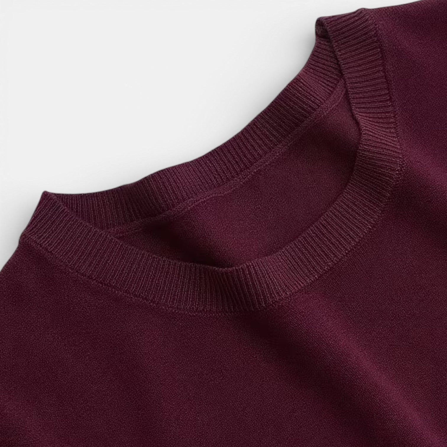 Dark red crewneck sweater with ribbed collar and neckline trim