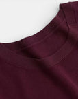 Dark red crewneck sweater with ribbed collar and neckline trim