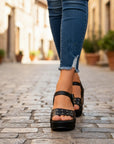 Black distressed leather open-toe wedge sandals with studded double straps