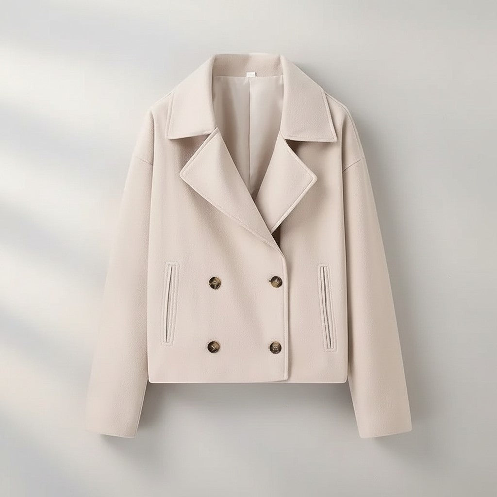 Beige double-breasted jacket with pointed lapels, four-button front, and flap pockets
