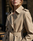 Beige trench coat detail view with wide collar, double-breasted buttons, and waist belt.