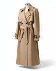 Beige women’s trench coat on mannequin with belted waist, epaulets, and buttoned placket.