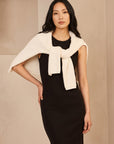 Black sleeveless ribbed knit midi dress, crew neck, fitted bodycon silhouette.