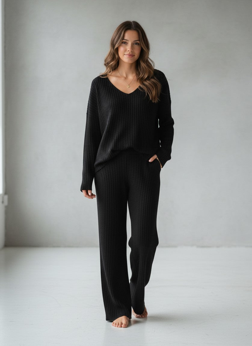BENJAMIN LONDON black ribbed knit V-neck loungewear set with wide leg pants.