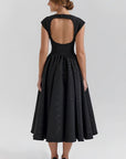 Back view black cap-sleeve midi dress with open back and gathered skirt