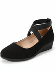 Black wedge ballet flats with T-bar straps and open arch, smooth suede-like finish.