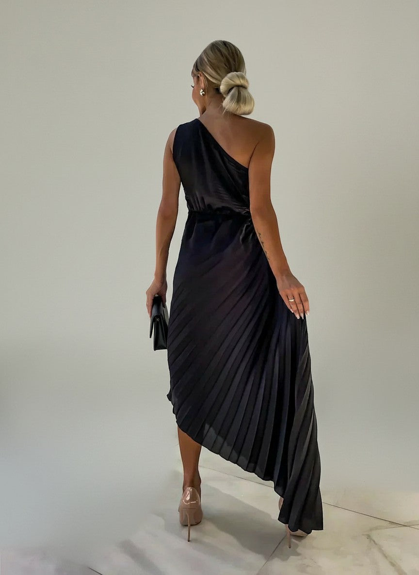 Dark pleated one-shoulder maxi dress with diagonal back strap and asymmetrical hem