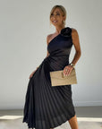 Black pleated one-shoulder maxi dress with ruched waist and diagonal neckline