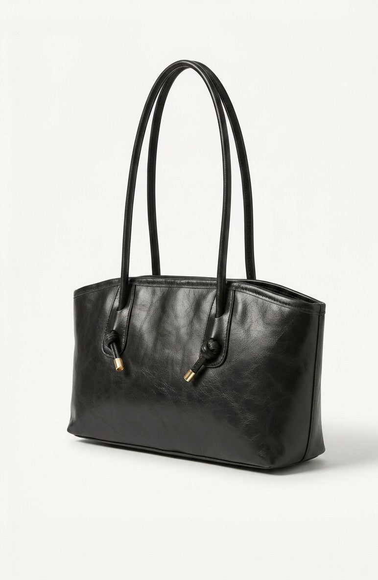 Black tote bag with long handles and gold hardware detail