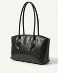 Black tote bag with long handles and gold hardware detail