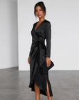 Black satin midi wrap dress side view with V-neck, long sleeves, tied waist, slit.
