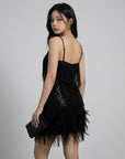 Black sequin mini dress with thin straps and feather trim around the hem