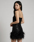 Black sequin mini dress with spaghetti straps and feathered hem detail