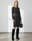 Black knee-high slouch boots with gold buckle at cuff, worn with dark dress