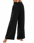 Black smocked high-waist wide-leg pants with gathered elastic waistband