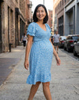Blue floral maternity dress with V-neck and flutter sleeves, side view