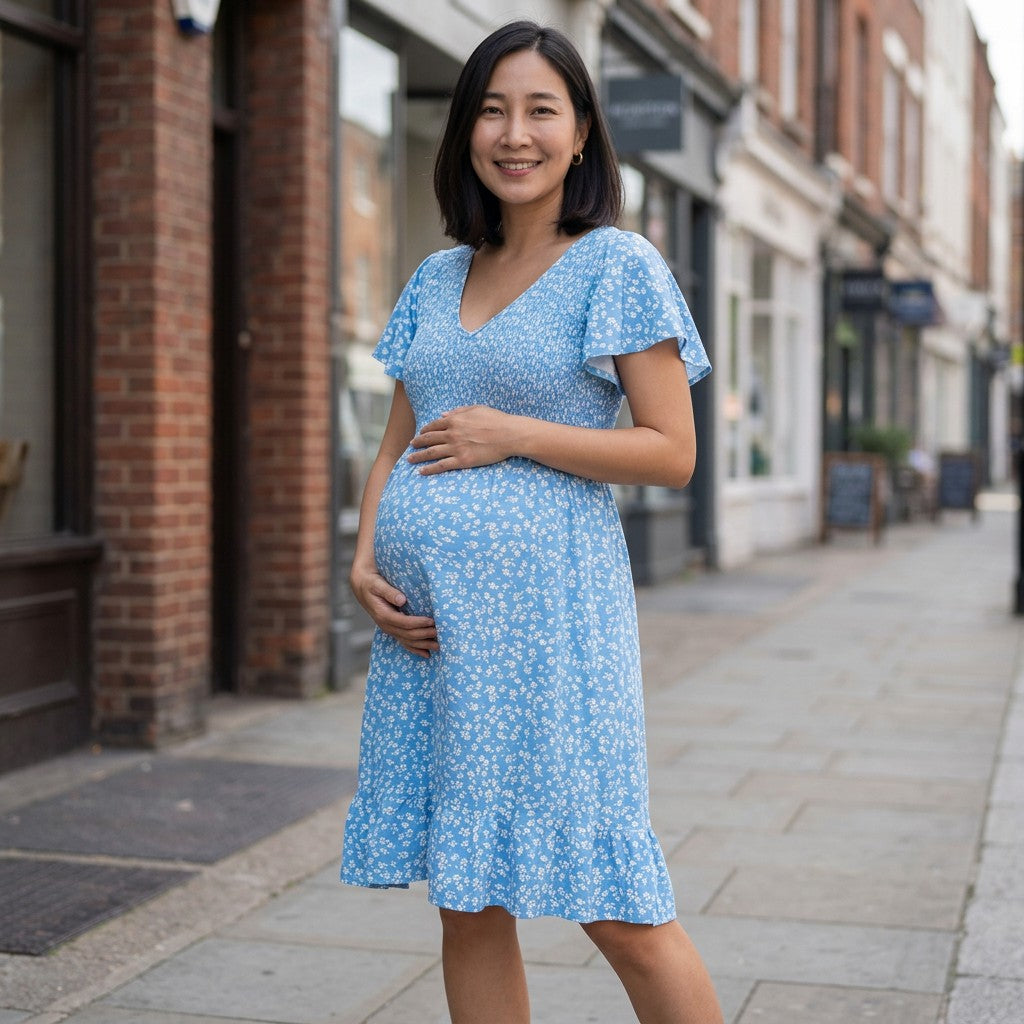 Blue floral maternity dress with V-neck and flutter sleeves, knee-length