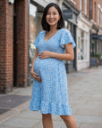 Blue floral maternity dress with V-neck and flutter sleeves, knee-length
