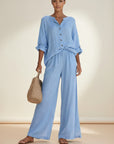 Light blue button-front blouse and wide-leg trousers set, rolled sleeves