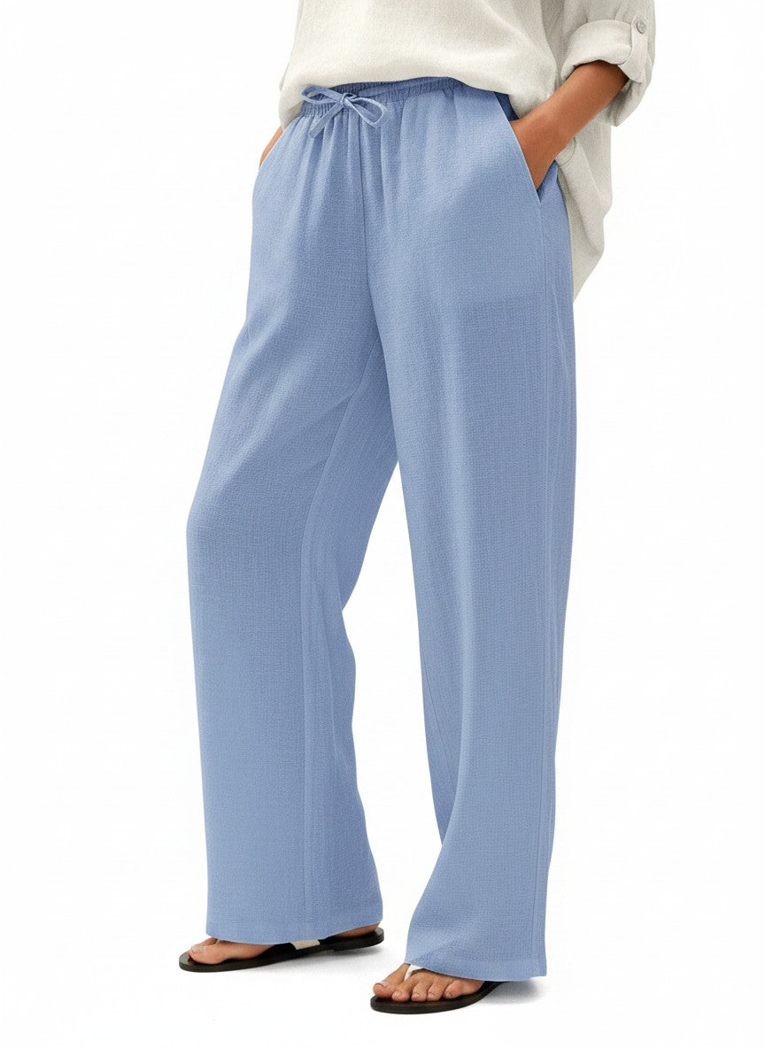 Light blue wide-leg linen pants with elastic waist and drawstring ties, relaxed full-length fit.