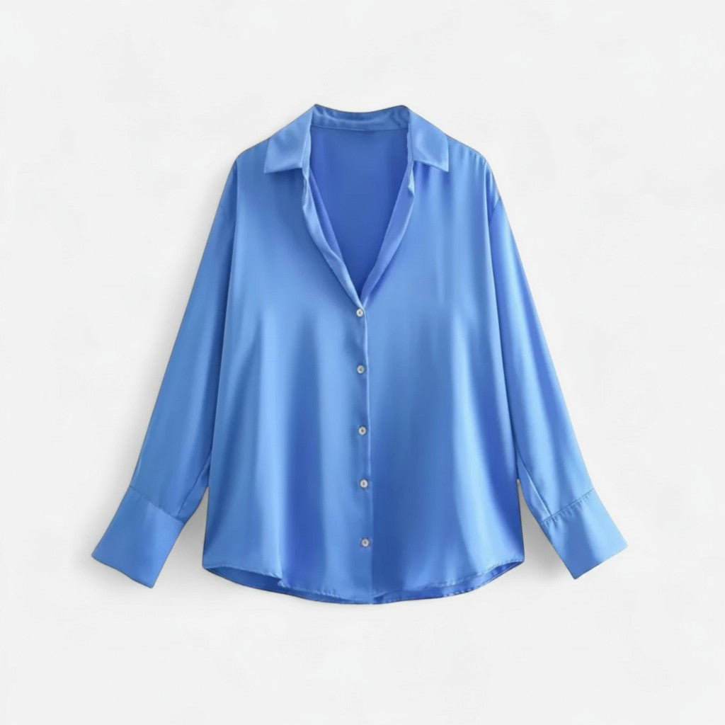 Light blue long-sleeve button-up blouse with pointed collar and front button placket