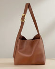 Brown slouchy shoulder bag with gold buckle strap