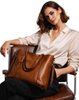 Cognac leather tote bag with long handles and front pocket detail