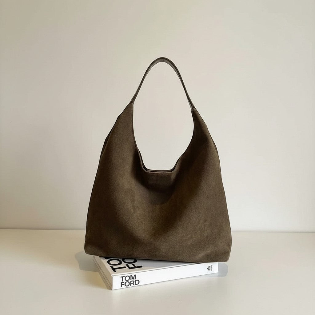 Olive-brown shoulder bag with open top and short handles on display.