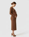 Women's brown ribbed knit maternity midi dress, long sleeves, V-neck placket, side view.