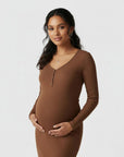 Women's brown ribbed knit maternity midi dress, long sleeves, V-neck placket, standing front view.