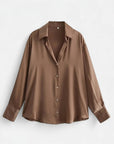 Brown long-sleeve button-up blouse with pointed collar and front button placket