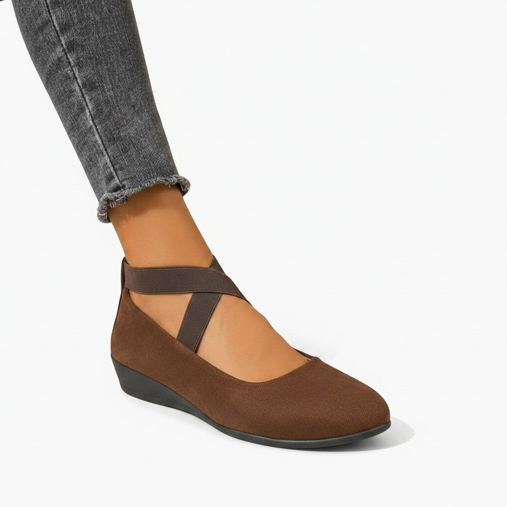 Brown wedge ballet flats with ankle strap and cross straps, closed toe.