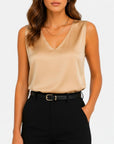 Beige satin sleeveless V-neck blouse with draped front.