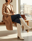 White suede cowboy boots with tall shaft, western stitch accents, and block heel