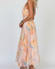 Women’s pastel floral halter maxi dress, sleeveless with fitted bodice and flared skirt