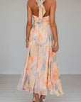 Women’s halter maxi dress with pastel floral print, open back tie and gathered waist