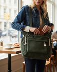 Green corduroy tote bag with front pocket and tassel zipper pulls