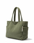 Corduroy tote bag in green with ribbed fabric, two top handles, and front pocket