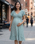 Teal floral maternity dress with V-neck and flutter sleeves, front view