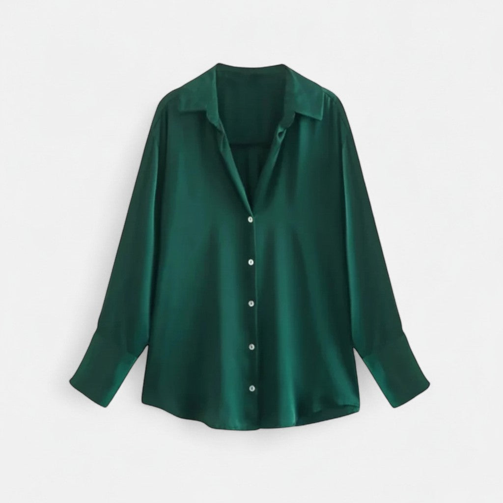 Deep green long-sleeve blouse on hanger with button front and pointed collar