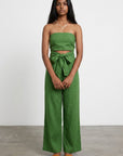 Green strapless wide-leg jumpsuit with bow-tied waist and fitted bodice